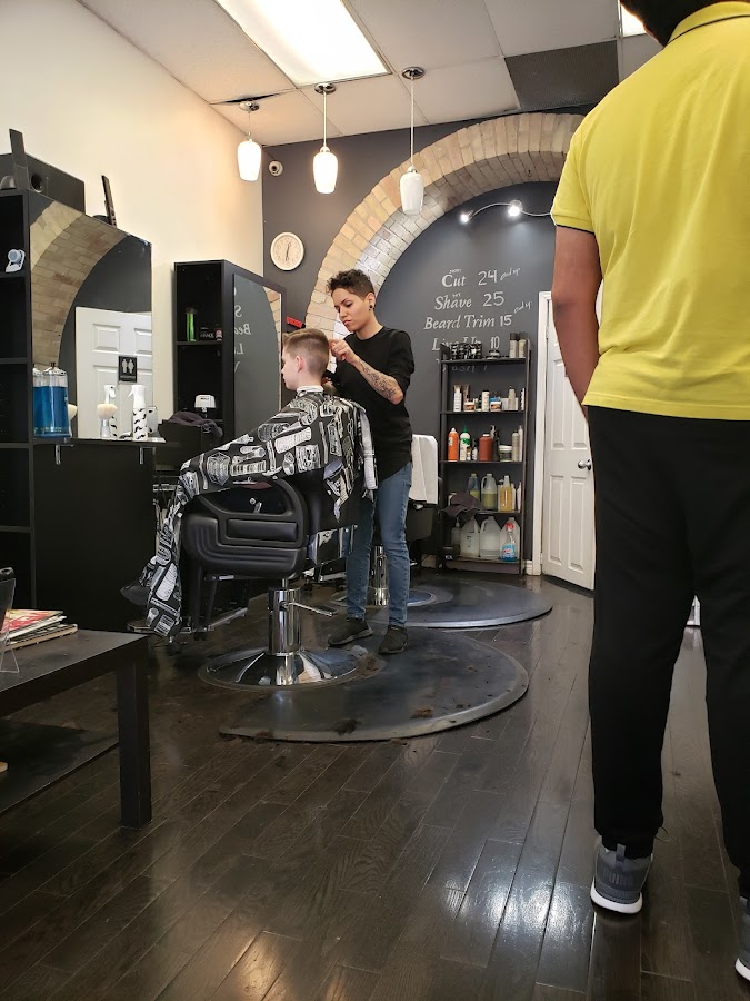 Barber cutting hair at Church Street Barber Shop